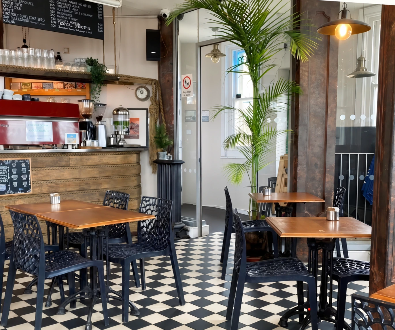 The café’s warmly lit interior, with tiled floors and wooden tables
